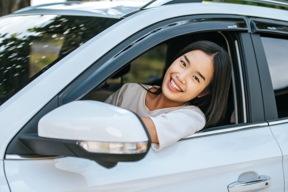 Seorang perempuan sedang mengemudi. Image by jcomp on Freepik